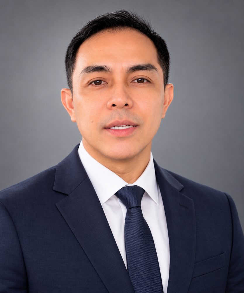 Dr. Ronald Samaniego, PT, DPT — The Angry Doc — professional headshot in navy suit